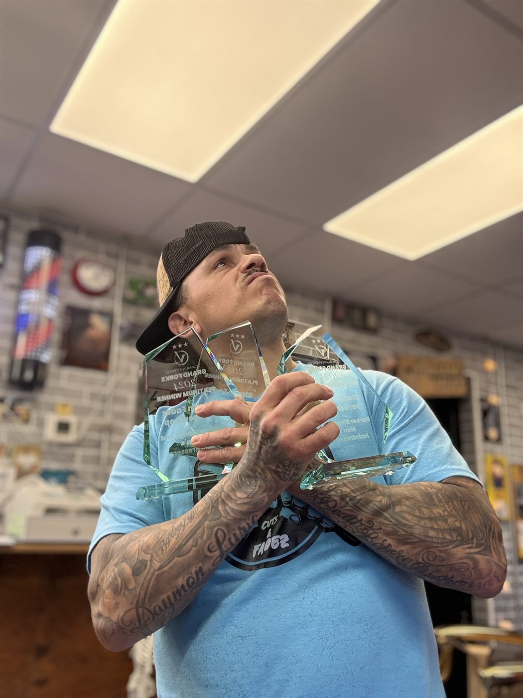 Community Votes Platinum Winner certificate on gold barber chair